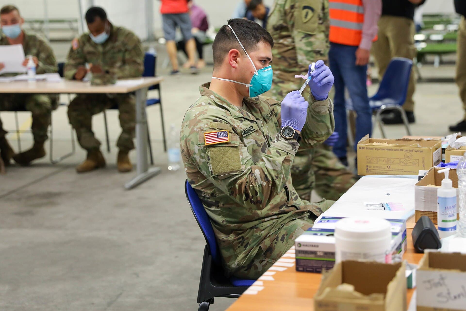 Army medics prepare doses of the measles, mumps and rubella vaccine