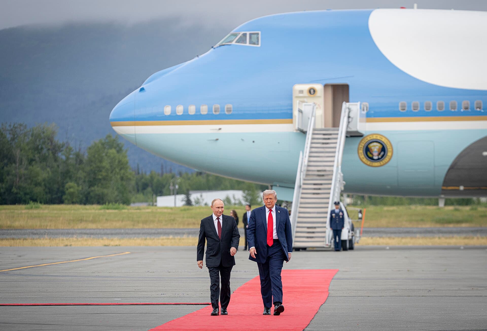 President Trump greets Russian President Vladimir Putin on a red carpet at Joint Base Elmendorf-Richardson in Alaska